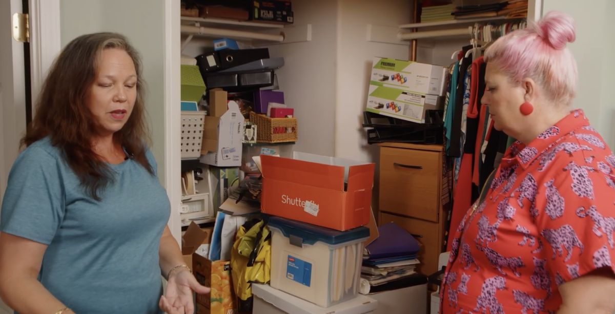 Karen and Unison talking in front of a packed closet.